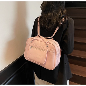 Close-up of pink JK uniform style bag with Noronoro embossing and adjustable straps