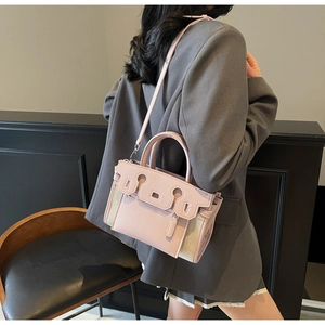 Chic pink colorblock shoulder bag with top handle and crossbody strap for daily commute.