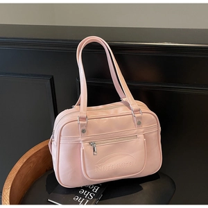 Top view of pink glossy oil wax leather bag with long handles and front zip detail