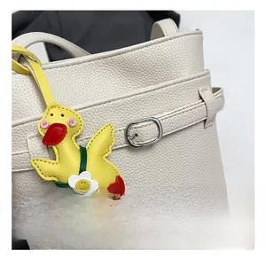 Dettaglio borsa a secchiello in pelle martell con ciondolo a forma di simpatica papera gialla