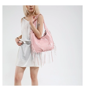Detail of light pink faux leather shoulder bag with long dual-tone fringe accents