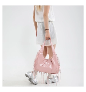 Detail van roze tote tas met lange franjes en een gladde glanzende PU-lederen afwerking