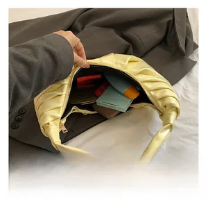 Interior view showing the large capacity of the pleated light yellow dumpling bag