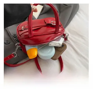 Interior view of the red leather bowling bag showing space for cosmetics and phone