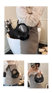 Detailed look at the black crescent bag showing handheld, shoulder and crossbody styles