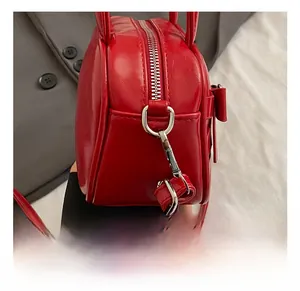 Detailed close-up of high-quality silver metal hooks on the red bowling bag
