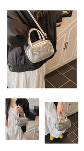 Detail of silver bowling bag with bow strap and detachable shoulder strap in macro view