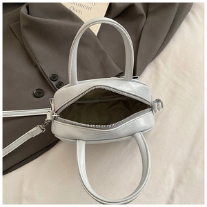 Top view of ice blue mini handbag showing spacious interior lining and top zipper detail
