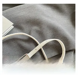 Adjustable white leather shoulder strap with silver buckle and fine stitching detail