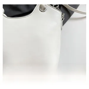 Close-up of premium cream white PU leather texture and silver metal ring hardware detail