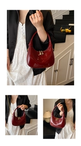 Detailed view of glossy burgundy patent leather half-moon bag with golden chain strap