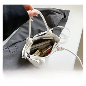 Top view of white bucket bag showing interior capacity for phone and makeup items