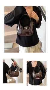 Detail view of glossy dark brown crescent bag featuring gold chain and beaded metal closure