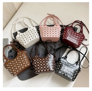 Flat lay of six studded bucket bags in white, pink, red, tan, coffee, and black