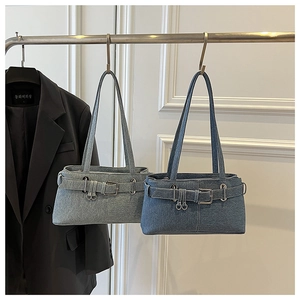 Detailed comparison of light and dark blue denim shoulder bags with buckle straps