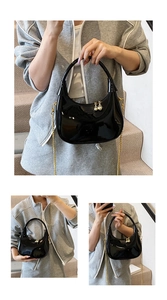 Detailed views of black patent leather dumpling bag with gold chain and ball charms