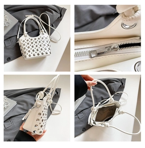 Detail view of white bucket bag with silver rivet studs and interior compartment
