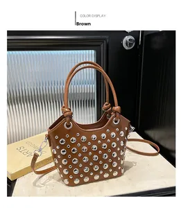 Detail of a brown bucket bag with metallic silver studs and detachable shoulder strap