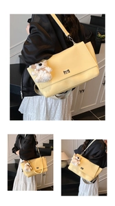 Detail of light yellow pebble leather crossbody bag with metal twist lock and bear charm