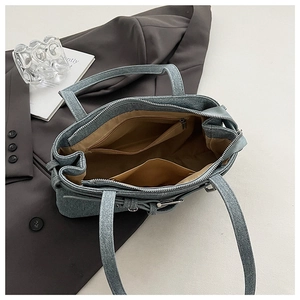 Internal structure of denim tote bag with brown lining, zipper pocket and inner slots