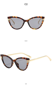 Detail view showing front and side of vintage tortoiseshell cat eye sunglasses with metal arms
