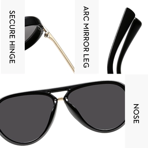 Detail view of gold reinforced hinges, arc legs and nose bridge on black pilot sunglasses