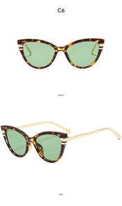 Detail view of cat eye sunglasses with tortoise frame and green lenses in model C6