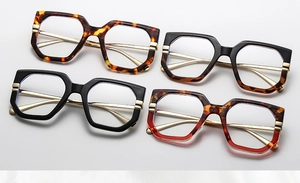 Detail of four colorful geometric polygon glasses frames with slim gold metal temples