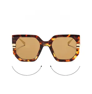 Detailed view of tortoiseshell frame sunglasses with golden metal hinges and light lenses
