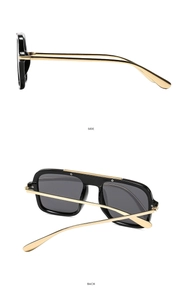 Detail view showing black square frame and gold metal temples of fashion sunglasses