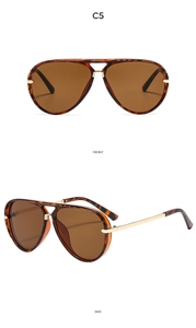 Detail view of tortoiseshell aviator sunglasses with gold metal temples and dark brown lenses