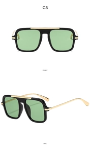 Close-up of square aviator sunglasses in black and gold frame with light green lenses