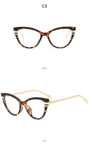 Detail view of cat eye glasses showing tortoiseshell frame and golden metal temples