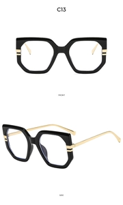 Front and side view of black hexagonal oversized frames with gold metal temples