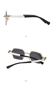 Detail of hexagonal metal sunglasses with woven texture frame and tricolor temples