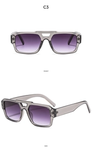 Détail de lunettes pilote double pont avec monture grise et verres violets dégradés