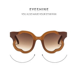 Detail of stylish amber brown wavy frame sunglasses with brown gradient lenses