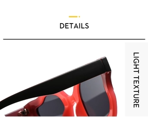 Detail of stylish oversized cat-eye sunglasses featuring red and black color-blocking
