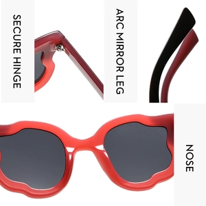 Detail view of reinforced hinges, arc legs, and nose pads on red cat-eye sunglasses