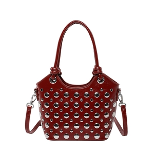 Deep red bucket bag with silver studs and top handles in polished finish