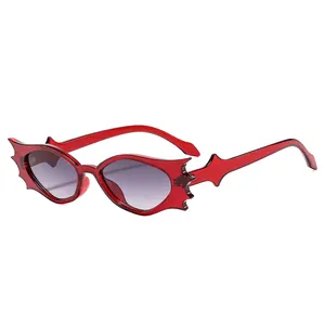 Trendy bat wing shaped sunglasses with red translucent frames and grey gradient lenses