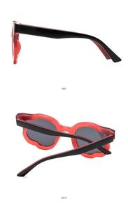 Side and back view of red floral scalloped sunglasses with black temple details