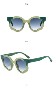 Detail view of wavy green cat-eye sunglasses frames and blue gradient lenses