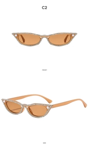 Détail de lunettes de soleil œil-de-chat avec strass et perles sur monture marron clair