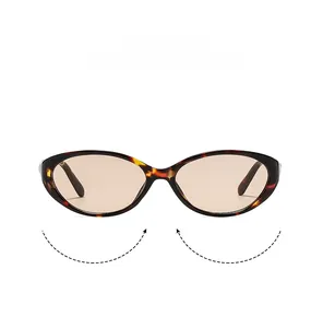 Detail view of tortoiseshell cat-eye sunglasses with amber frames and brown tinted lenses