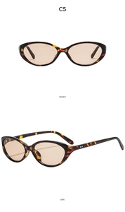 Detail view of cat eye sunglasses featuring tortoiseshell frames and tea tinted lenses