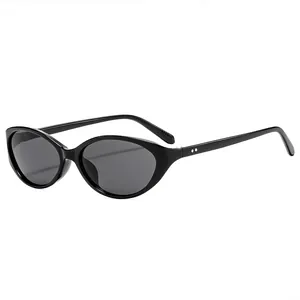 Retro black cat-eye sunglasses with dark lenses and metal stud detail on a white background