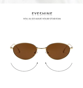 Detail of oval sunglasses with slim gold metal frame and tinted brown lenses