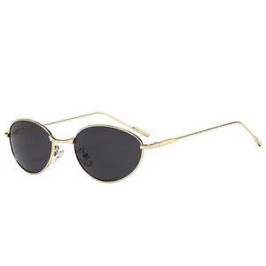 Retro oval sunglasses with golden metal frame and dark UV protective lenses for outdoors