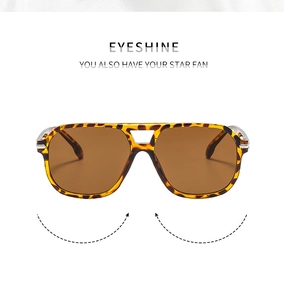 Detail view of double-bridge aviator sunglasses with leopard print frame and brown lenses